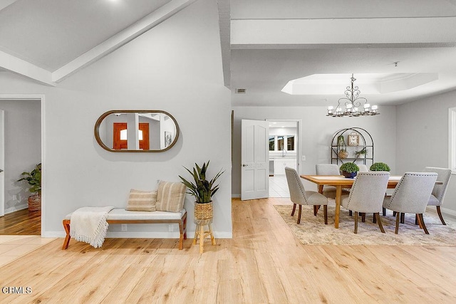 2735 Los Pinos Cir, Camarillo, CA 93012 - dining room with wood finished floors, a chandelier, baseboards, and a raised ceiling
