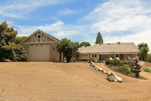 2735 Los Pinos Cir, Camarillo, CA 93012 - view of front of home featuring dirt driveway, an attached garage, and stucco siding