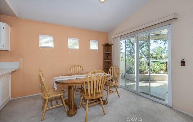 689 Twin Hills Dr, Banning, CA 92220 - dining room featuring light colored carpet, baseboards, and lofted ceiling