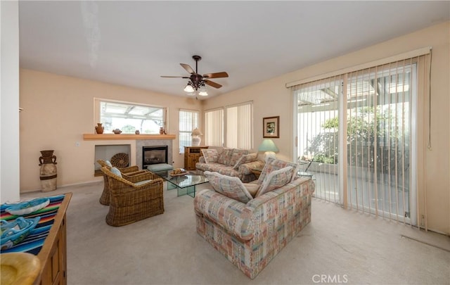 689 Twin Hills Dr, Banning, CA 92220 - living room with light colored carpet, ceiling fan, and a glass covered fireplace
