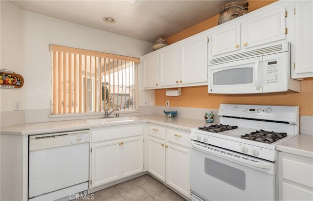 689 Twin Hills Dr, Banning, CA 92220 - kitchen with white appliances, a sink, white cabinets, and light countertops