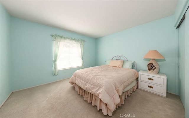 689 Twin Hills Dr, Banning, CA 92220 - bedroom featuring light carpet, baseboards, and a closet