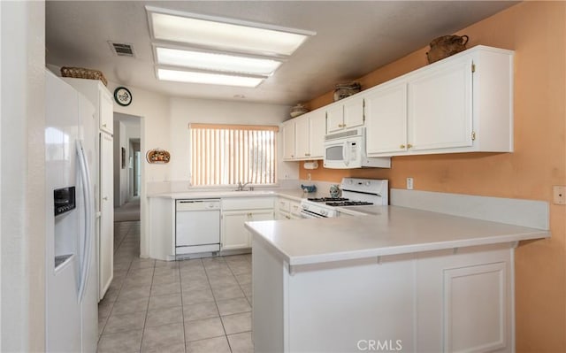 689 Twin Hills Dr, Banning, CA 92220 - kitchen with white appliances, a peninsula, light countertops, white cabinets, and light tile patterned floors