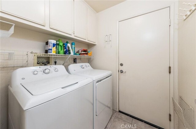 689 Twin Hills Dr, Banning, CA 92220 - laundry room featuring separate washer and dryer, cabinet space, and light tile patterned floors