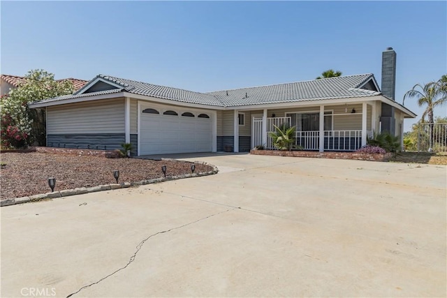 24048 Cruise Circle Dr, Canyon Lake, CA 92587 - view of front of house with an attached garage, driveway, covered porch, a chimney, and a tiled roof