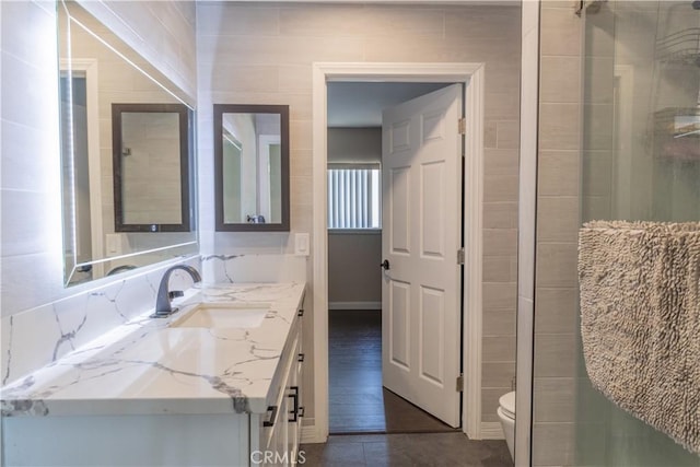 24048 Cruise Circle Dr, Canyon Lake, CA 92587 - bathroom with toilet, vanity, a shower with door, baseboards, and tile patterned flooring