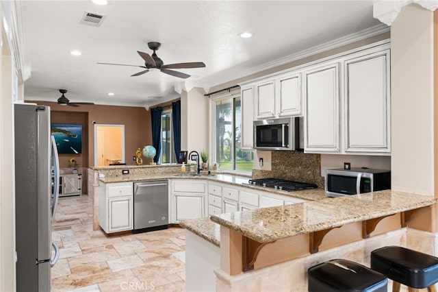 18936 Summerleaf Ln, Riverside, CA 92504 - kitchen featuring stainless steel appliances, a peninsula, a sink, ceiling fan, and recessed lighting