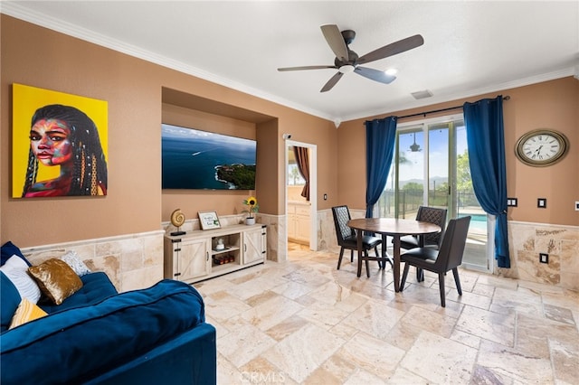 18936 Summerleaf Ln, Riverside, CA 92504 - living room featuring a wainscoted wall, ornamental molding, stone tile flooring, a ceiling fan, and tile walls