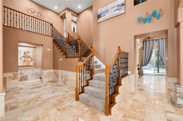18936 Summerleaf Ln, Riverside, CA 92504 - stairs featuring a high ceiling, stone tile floors, and recessed lighting