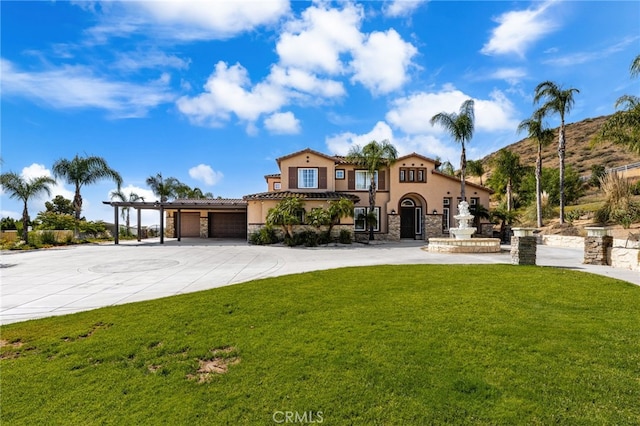 18936 Summerleaf Ln, Riverside, CA 92504 - mediterranean / spanish home featuring stucco siding, a front lawn, stone siding, and concrete driveway