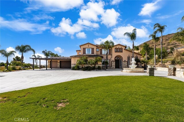 18936 Summerleaf Ln, Riverside, CA 92504 - mediterranean / spanish-style home with stucco siding, a front yard, stone siding, and concrete driveway