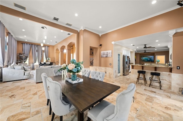 18936 Summerleaf Ln, Riverside, CA 92504 - dining area featuring arched walkways, crown molding, recessed lighting, a ceiling fan, and stone tile flooring
