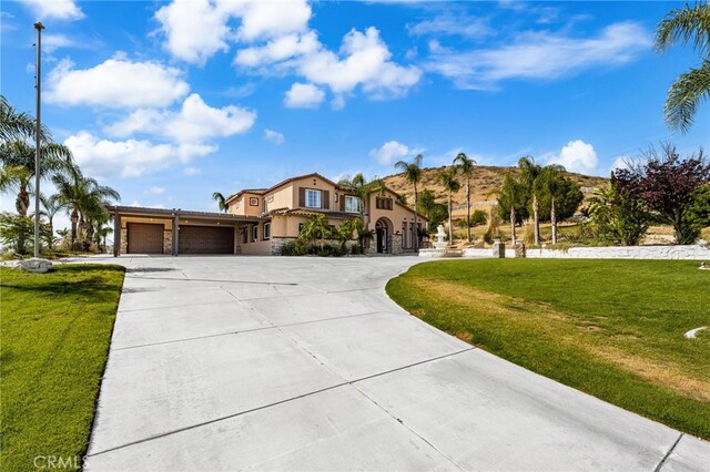 18936 Summerleaf Ln, Riverside, CA 92504 - mediterranean / spanish house with an attached garage, driveway, stucco siding, and a front yard
