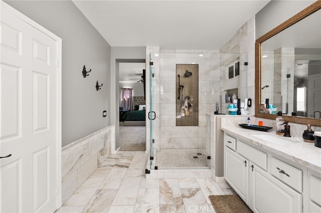 18936 Summerleaf Ln, Riverside, CA 92504 - ensuite bathroom featuring vanity, a shower stall, ceiling fan, tile walls, and marble finish flooring