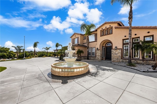 18936 Summerleaf Ln, Riverside, CA 92504 - view of front of property with stucco siding, stone siding, and a tiled roof