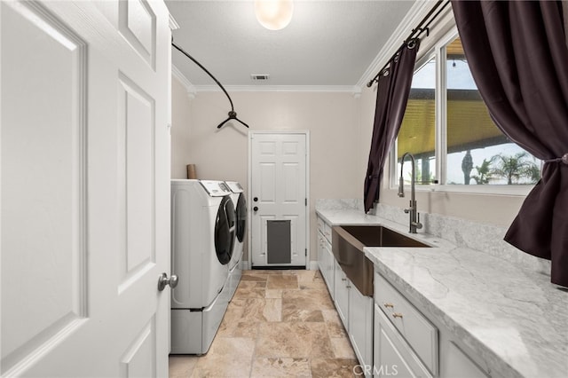 18936 Summerleaf Ln, Riverside, CA 92504 - laundry room with ornamental molding, light stone finish floors, washing machine and clothes dryer, cabinet space, and a textured ceiling