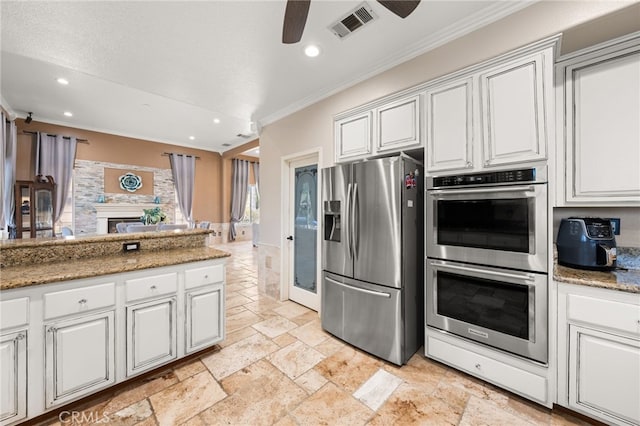 18936 Summerleaf Ln, Riverside, CA 92504 - kitchen featuring stainless steel appliances, ornamental molding, recessed lighting, ceiling fan, and stone tile floors
