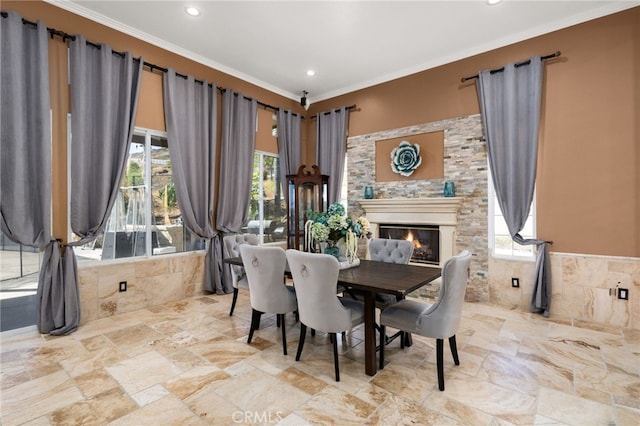 18936 Summerleaf Ln, Riverside, CA 92504 - dining area with healthy amount of natural light, ornamental molding, recessed lighting, stone finish flooring, and a glass covered fireplace