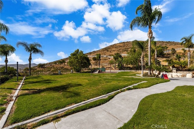 18936 Summerleaf Ln, Riverside, CA 92504 - surrounding community featuring a mountain view and a lawn