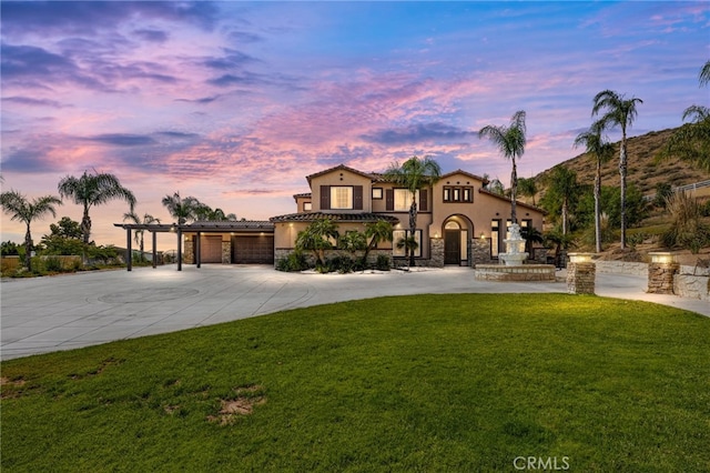 18936 Summerleaf Ln, Riverside, CA 92504 - mediterranean / spanish house with stucco siding, a front lawn, and curved driveway