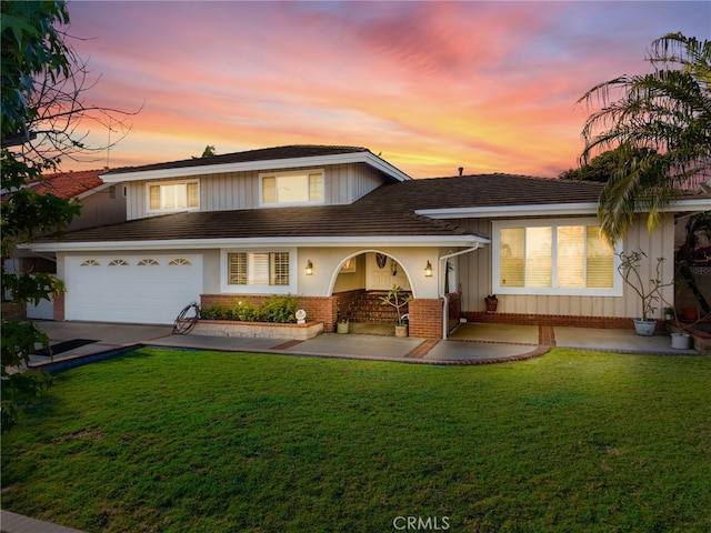 419 Clairmont Ave, Placentia, CA 92870 - tri-level home featuring a yard, concrete driveway, board and batten siding, and brick siding