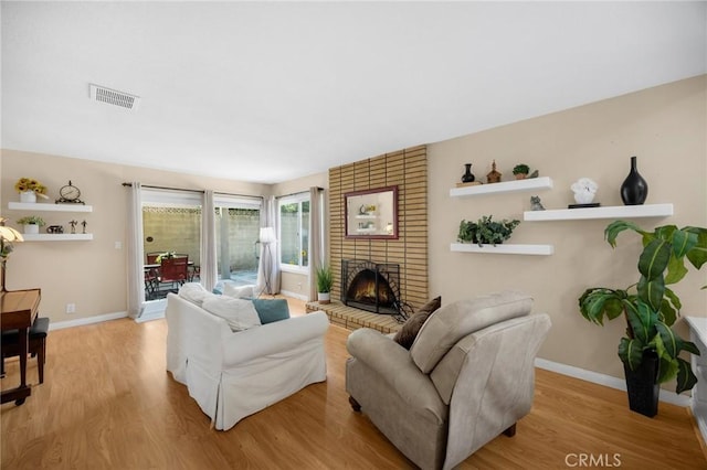 419 Clairmont Ave, Placentia, CA 92870 - living room featuring wood finished floors, a brick fireplace, and baseboards