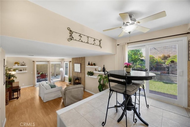419 Clairmont Ave, Placentia, CA 92870 - dining area with a ceiling fan, baseboards, light wood-style floors, and a fireplace