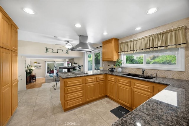 419 Clairmont Ave, Placentia, CA 92870 - kitchen with island range hood, a sink, dark stone countertops, decorative backsplash, and a peninsula