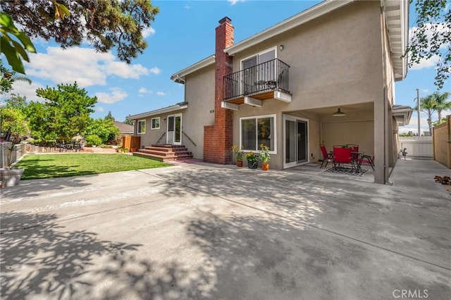 419 Clairmont Ave, Placentia, CA 92870 - rear view of house with a balcony, stucco siding, a chimney, and a patio