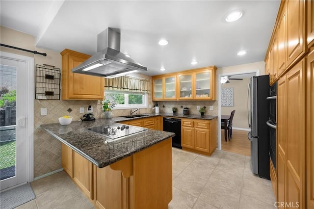 419 Clairmont Ave, Placentia, CA 92870 - kitchen featuring island exhaust hood, a peninsula, a sink, black appliances, and glass insert cabinets