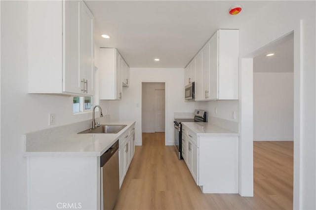 15058 Gale Ave, Hacienda Heights, CA 91745 - kitchen with appliances with stainless steel finishes, a sink, light wood-style floors, light countertops, and white cabinets
