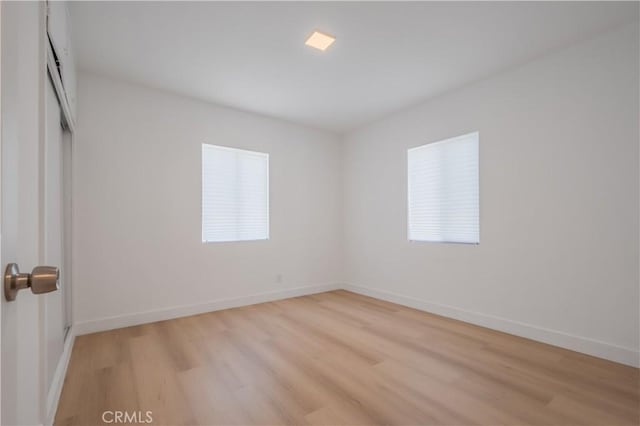 15058 Gale Ave, Hacienda Heights, CA 91745 - unfurnished bedroom with light wood-type flooring, multiple windows, and baseboards