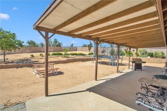 18603 Mecca St, Hesperia, CA 92345 - fenced backyard featuring a trampoline, a patio, and grilling area
