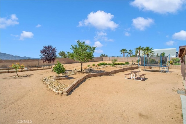 18603 Mecca St, Hesperia, CA 92345 - view of yard featuring a trampoline