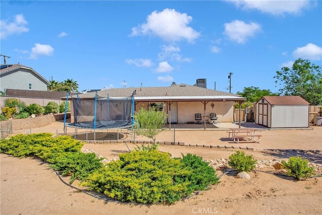 18603 Mecca St, Hesperia, CA 92345 - rear view of property featuring a trampoline, a patio, and a chimney