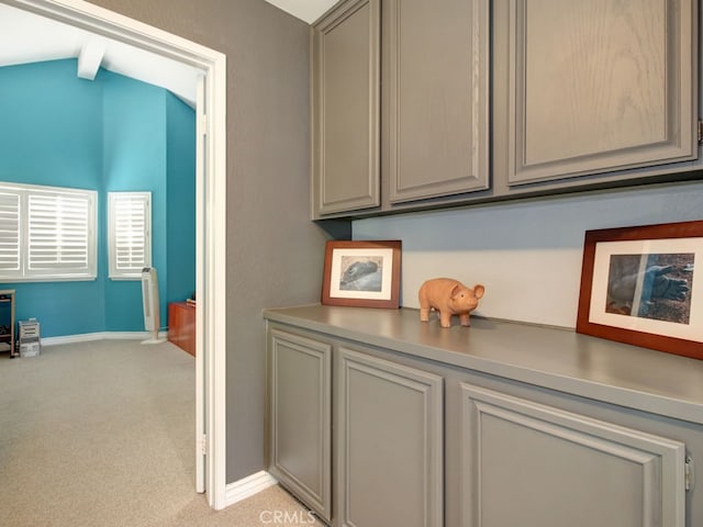 1400 Ashley Pl, Upland, CA 91784 - hallway with light carpet, vaulted ceiling, and baseboards