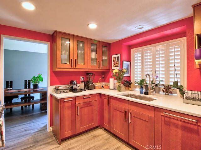 1400 Ashley Pl, Upland, CA 91784 - kitchen featuring a sink, light countertops, glass insert cabinets, light wood finished floors, and recessed lighting