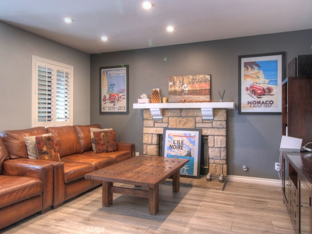 1400 Ashley Pl, Upland, CA 91784 - living area with wood finished floors, recessed lighting, a stone fireplace, and baseboards