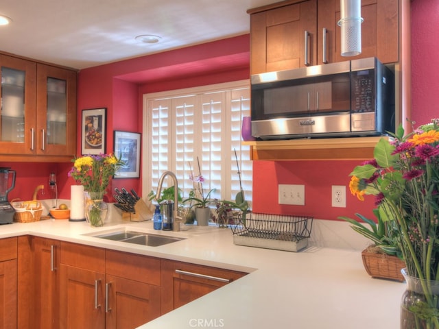 1400 Ashley Pl, Upland, CA 91784 - kitchen featuring stainless steel microwave, a sink, light countertops, brown cabinets, and recessed lighting