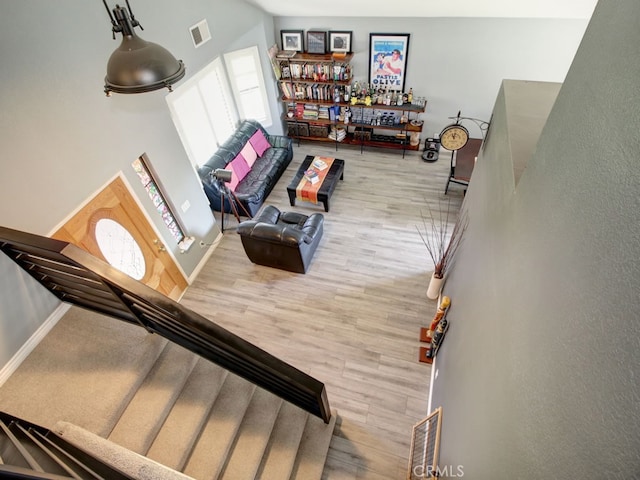 1400 Ashley Pl, Upland, CA 91784 - living area featuring a towering ceiling, wood finished floors, and baseboards