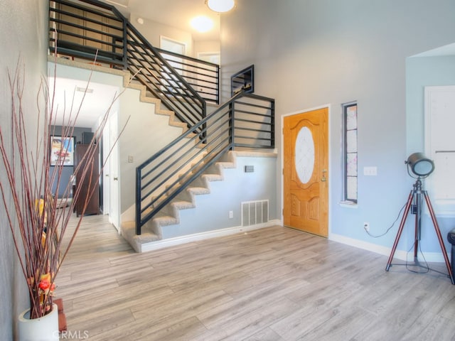 1400 Ashley Pl, Upland, CA 91784 - entrance foyer featuring stairway, a high ceiling, wood finished floors, and baseboards