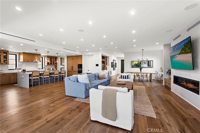 213 Avenida Princesa, San Clemente, CA 92672 - living area with recessed lighting, dark wood-type flooring, a glass covered fireplace, and a chandelier