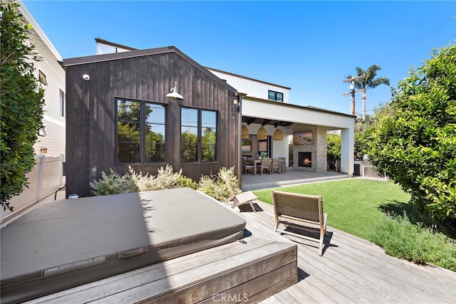 213 Avenida Princesa, San Clemente, CA 92672 - deck with a covered hot tub, a lit fireplace, and a yard