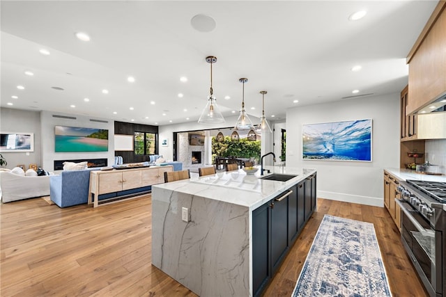 213 Avenida Princesa, San Clemente, CA 92672 - kitchen featuring a sink, double oven range, recessed lighting, a spacious island, and light wood-type flooring