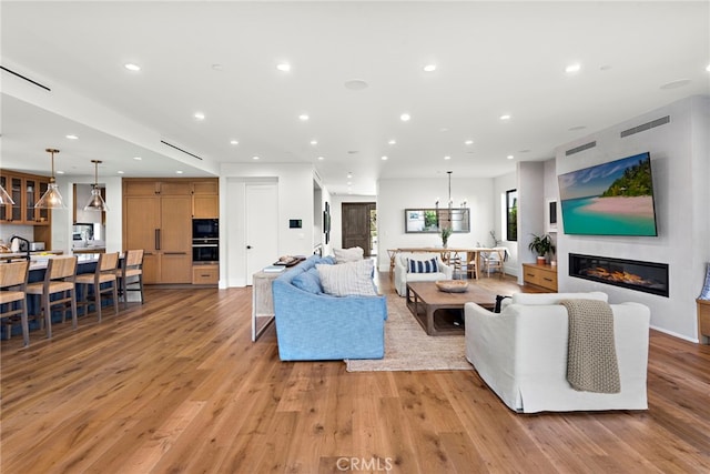 213 Avenida Princesa, San Clemente, CA 92672 - living area featuring recessed lighting, light wood-style floors, and a glass covered fireplace