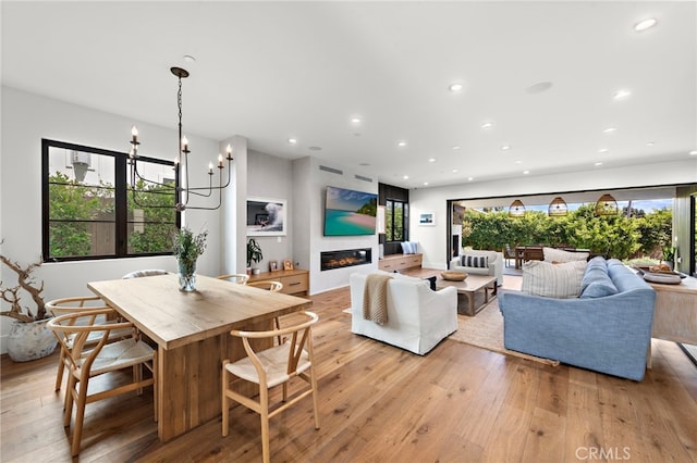 213 Avenida Princesa, San Clemente, CA 92672 - dining room with light wood finished floors, a glass covered fireplace, recessed lighting, and a chandelier