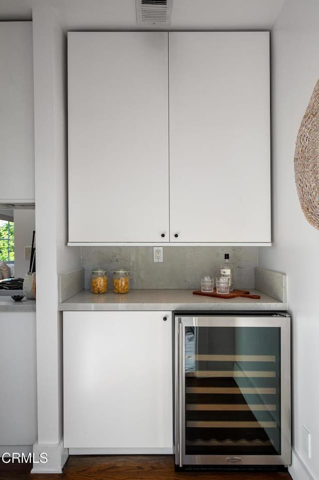 4865 Granada St, Los Angeles, CA 90042 - indoor dry bar featuring wine cooler, wood finished floors, and tasteful backsplash