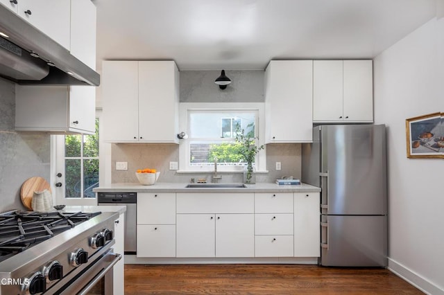 4865 Granada St, Los Angeles, CA 90042 - kitchen with stainless steel appliances, under cabinet range hood, a sink, light countertops, and decorative backsplash
