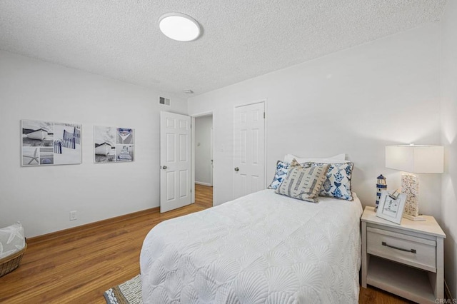 3925 Linmar Ln, Carlsbad, CA 92008 - bedroom with a textured ceiling and wood finished floors