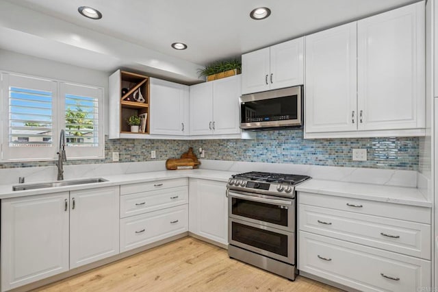 3925 Linmar Ln, Carlsbad, CA 92008 - kitchen with stainless steel appliances, white cabinets, open shelves, backsplash, and recessed lighting
